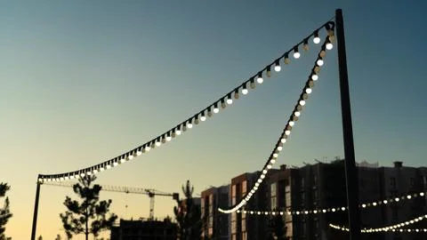 Lanterns in a modern area in the evening with a sunset sky Stock Photos