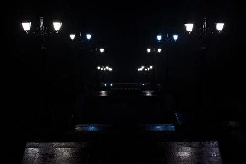 Lanterns in park on stairs that going down in the dark Stock Photos