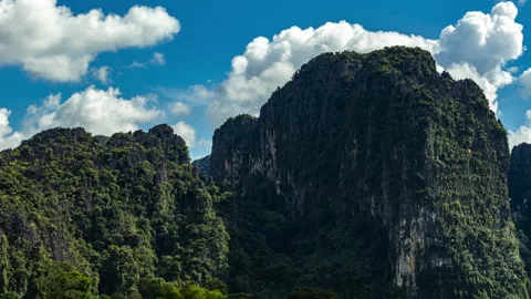 Laos dramatic limestone karsts lush tropical vegetation mountain landscape blue Stock Footage 317442345