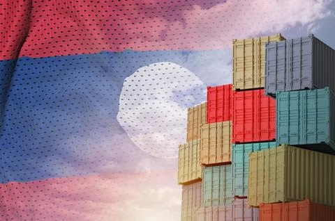 Laos flag and big stack of shipping cargo containers in docks with sky Stock Photos