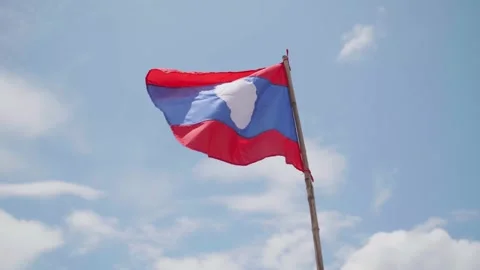 Laos flag flapping in the wind at sunset in the mountain town in Laos 스톡 동영상 344311217
