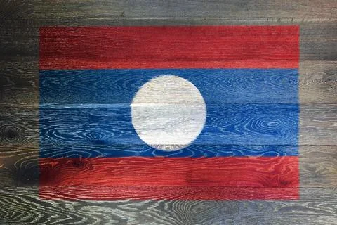 Laos flag on rustic old wood surface background Photos