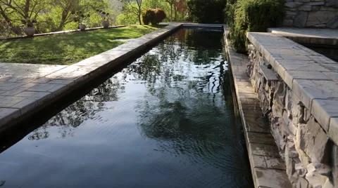 LAP POOL AND WATER FEATURE TURNING ON (TIGHTER) Stock Footage 67638564