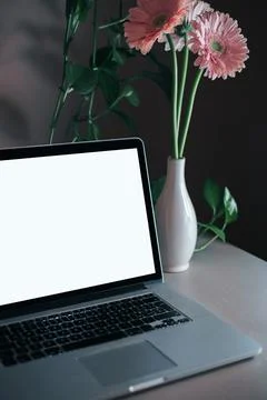 Lap top blank screen on desk room dark Stock Photos