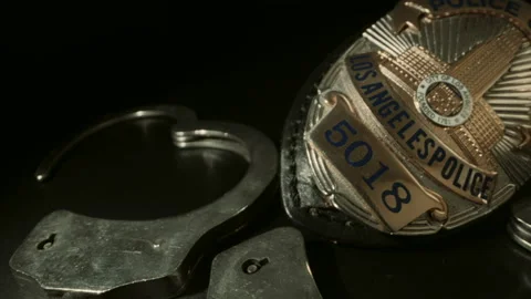 LAPD BADGE AND HANDCUFFS.  ECU SLIDER SHOT.  NO PEOPLE. Stock Footage 156464225
