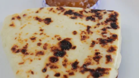 Lapland cheese with cloudberry jam on a white plate Stock Footage 60406065