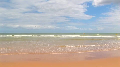 Lapping pristine waves with thick moving clouds, Omaha Beach. Normandy France Stock Footage 104222496