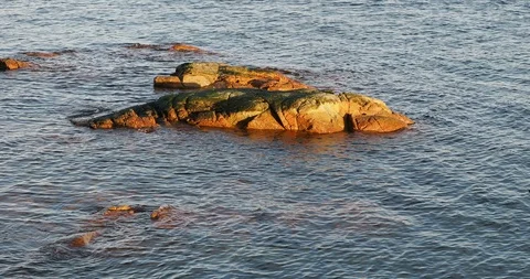 Lapping water with rocks Stock Footage 123673564