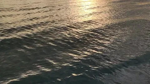 Lapping waves still calm beach golden sunset with sound Stock Footage 158499018