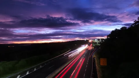 Lapse capturing the luminous trails of car headlights and taillights on highway Stock Footage 330306606