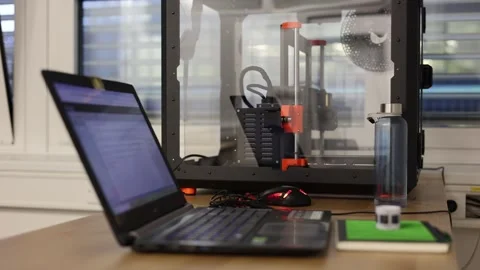 Laptop and 3D printer on the table Stock Footage 286048895