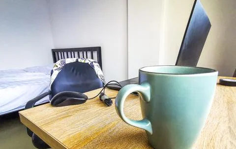 Laptop and coffee cup on table showing digital nomad lifestyle Thailand. Stock Photos