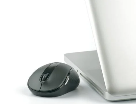 Laptop and computer mouse Stock Photos