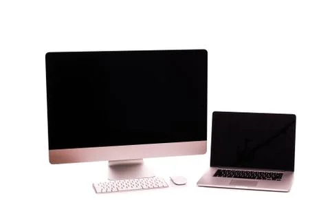 Laptop and computer screen on a white table with reflection on white backgrou Stock Photos