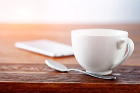 Laptop and cup of tea on rustic wooden table. Stock Photos