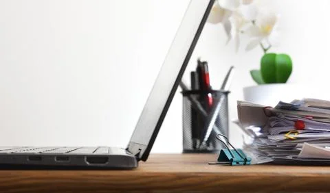 Laptop and Document Stack on Office Desk Fotos Stock