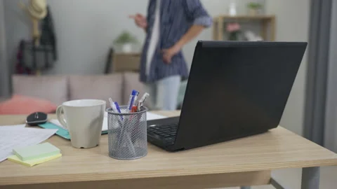 Laptop and documents on an office desk in a home Stock Footage 163693424