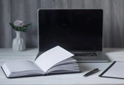 Laptop and documents in the workplace. Stock Photos