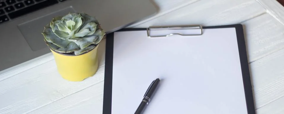 Laptop and documents in the workplace. Stock Photos