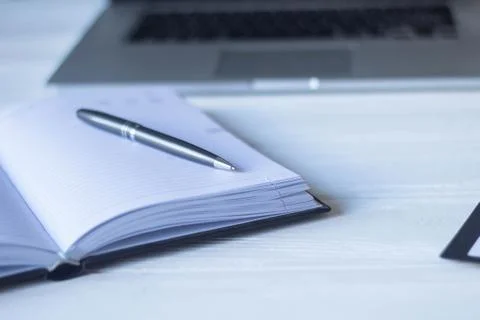 Laptop and documents in the workplace. Stock Photos