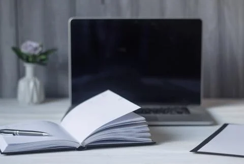 Laptop and documents in the workplace. Stock Photos