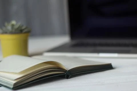 Laptop and documents in the workplace. Stock Photos