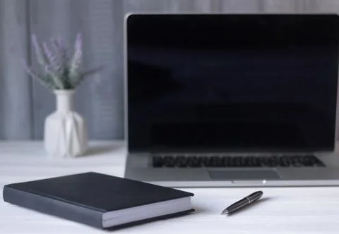 Laptop and documents in the workplace. Stock Photos