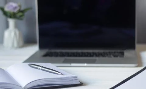 Laptop and documents in the workplace. Stock Photos