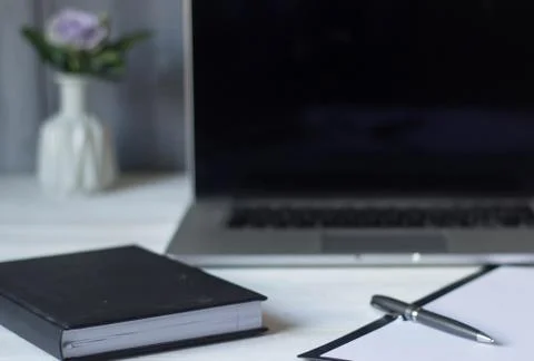 Laptop and documents in the workplace. Stock Photos