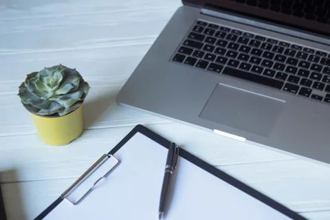 Laptop and documents in the workplace. Stock Photos