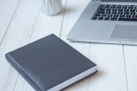 Laptop and documents in the workplace. Stock Photos