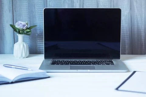 Laptop and documents in the workplace. Stock Photos