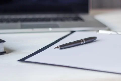 Laptop and documents in the workplace. Stock Photos