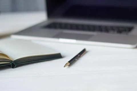 Laptop and documents in the workplace. Stock Photos