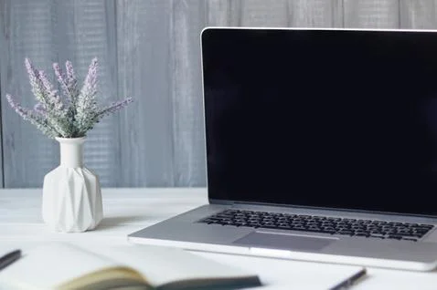 Laptop and documents in the workplace. Stock Photos