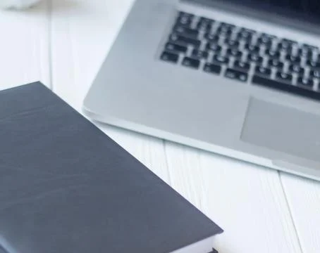 Laptop and documents in the workplace. Stock Photos