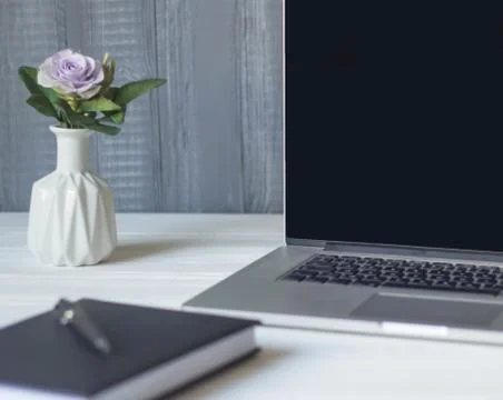 Laptop and documents in the workplace. Stock Photos