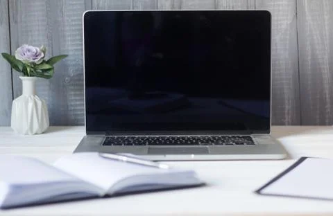 Laptop and documents in the workplace. Stock Photos