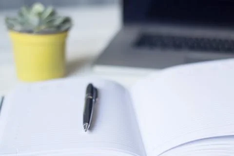 Laptop and documents in the workplace. Stock Photos