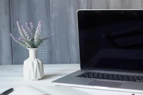 Laptop and documents in the workplace. Stock Photos