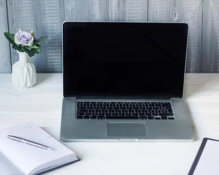 Laptop and documents in the workplace. Stock Photos