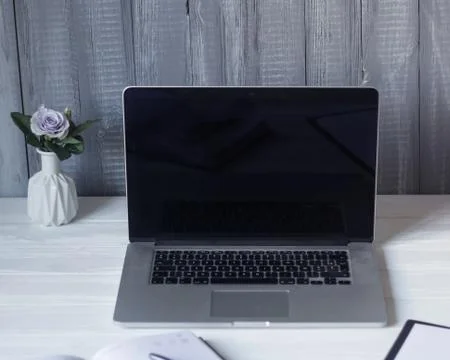 Laptop and documents in the workplace. Stock Photos