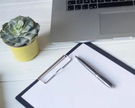 Laptop and documents in the workplace. Stock Photos