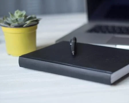 Laptop and documents in the workplace. Stock Photos