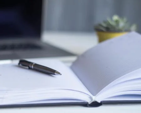 Laptop and documents in the workplace. Stock Photos