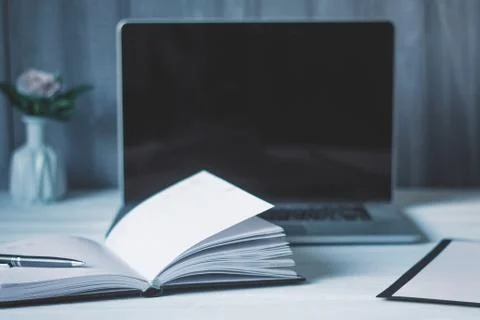 Laptop and documents in the workplace. Stock Photos