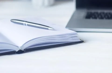 Laptop and documents in the workplace. Stock Photos