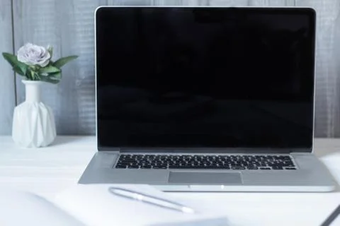 Laptop and documents in the workplace. Stock Photos