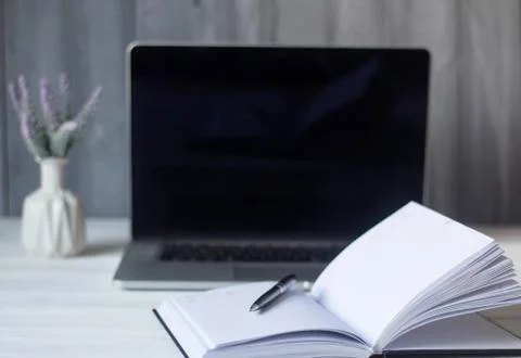 Laptop and documents in the workplace. Stock Photos