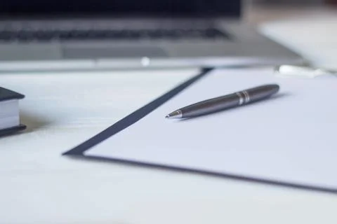 Laptop and documents in the workplace. Stock Photos